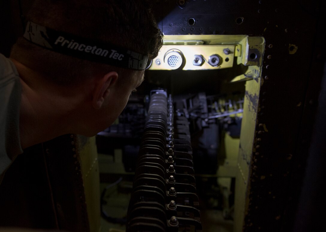 U.S. Army Pfc. Zackary Cordova, Bravo Company, 222nd Aviation Regiment, 1st Aviation Battalion, 128th Aviation Brigade, inspects the installation of an ammunition conveyer assembly during an AH-64 Armament/Electrical/Avionic Systems Repairer course at Joint Base Langley-Eustis, Virginia, June 10, 2019.