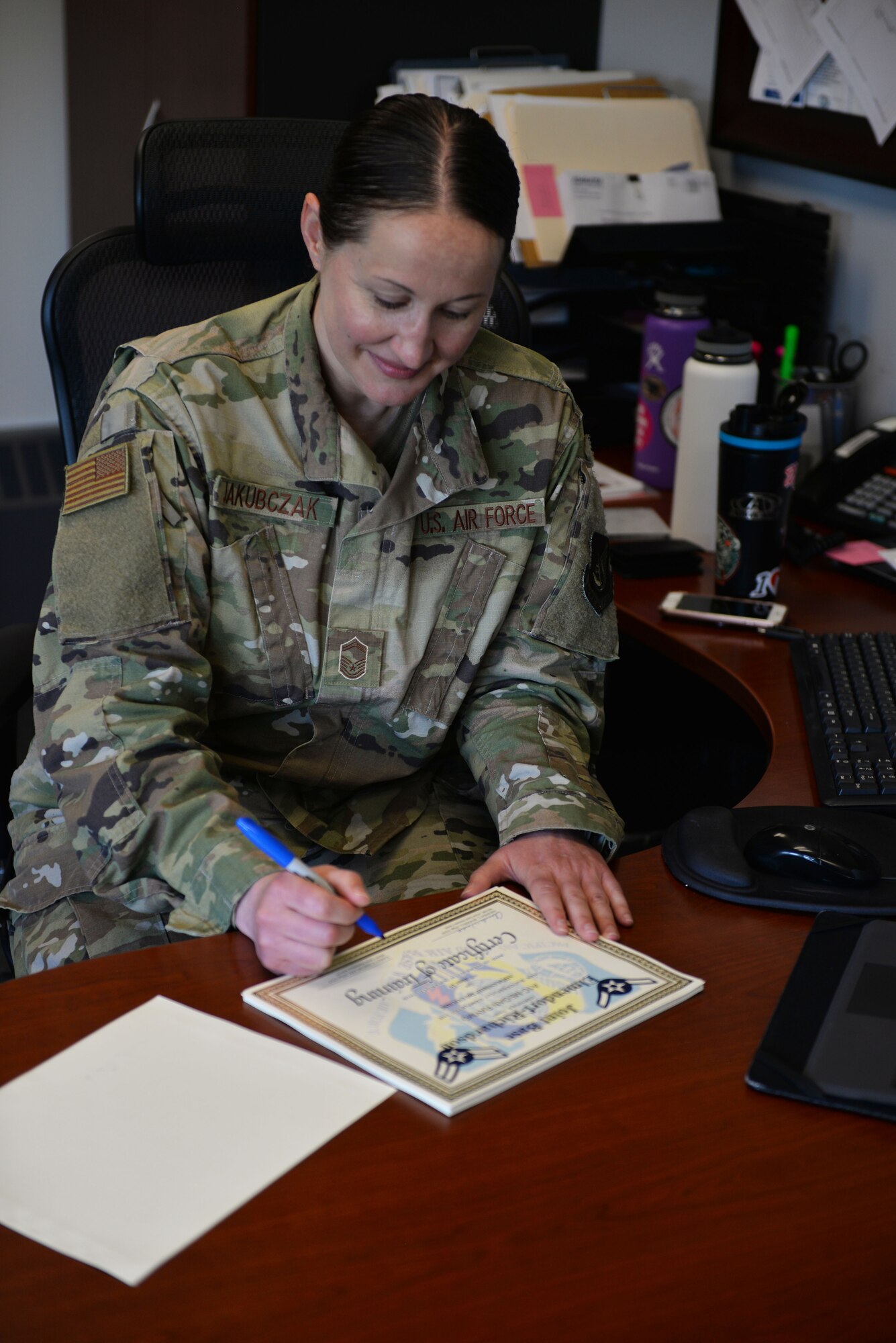 Senior Master Sgt. Karen Jakubczak, 673rd Force Support Squadron career assistance Advisor, signs certificates of completion of the FTAC Airman Course June 3, 2019, at Joint Base Elmendorf-Richardson, Alaska. Jakubczak oversees FTAC and other leadership courses such as Retraining 101, Non-Commissioned Officer Professional Enhancement Seminar and Senior Non-Commissioned Officer Professional Enhancement Seminar.