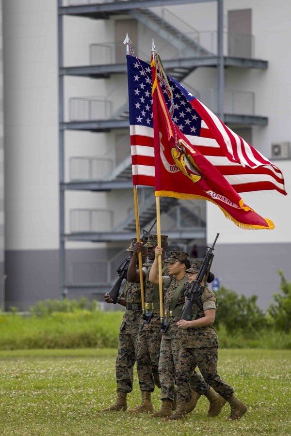 U.S. Marines with Combat Logistics Regiment 35, 3rd Marine Logistics Group, march on the regimental colors during a relief and appointment ceremony May 31, 2019, at Camp Kinser, Okinawa, Japan. Sgt. Maj. Kenneth A. Miller ceremoniously transferred accountability and authority of enlisted Marines to Sgt. Maj. John R. Preston during the ceremony. Miller, the outgoing regimental sergeant major of CLR-35, 3rd MLG, is a native of Woodland, California. Preston, the incoming regimental sergeant major of CLR-35, 3rd MLG, is a native of Easley, South Carolina. (U.S. Marine Corps photo by Lance Cpl. Terry Wong)
