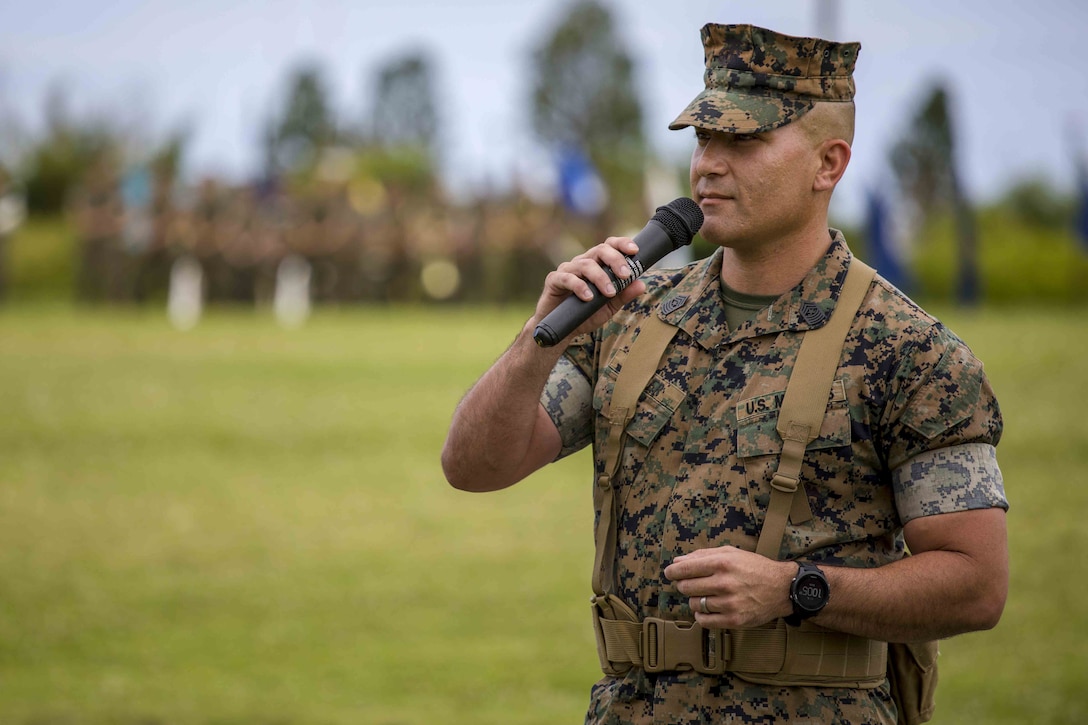 U.S. Marine Corps Sgt. Maj. Kenneth A. Miller addresses Marines and families of 3rd Marine Logistics Group, during a relief and appointment ceremony May 31, 2019, at Camp Kinser, Okinawa, Japan. Sgt. Maj. Kenneth A. Miller ceremoniously transferred accountability and authority of enlisted Marines to Sgt. Maj. John R. Preston during the ceremony. Miller, the outgoing regimental sergeant major of Combat Logistics Regiment 35, 3rd MLG, is a native of Woodland, California. (U.S. Marine Corps photo by Lance Cpl. Terry Wong)