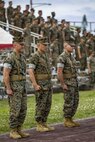 U.S. Marines and Sailors of 3rd MLG, stand at attention during the playing of Anchors Aweigh at a relief and appointment ceremony May 31, 2019, at Camp Kinser, Okinawa, Japan. Sgt. Maj. Kenneth A. Miller ceremoniously transferred accountability and authority of enlisted Marines to Sgt. Maj. John R. Preston during the ceremony. Miller, the outgoing regimental sergeant major of CLR-35, 3rd MLG, is a native of Woodland, California. Preston, the incoming regimental sergeant major of CLR-35, 3rd MLG, is a native of Easley, South Carolina. (U.S. Marine Corps photo by Lance Cpl. Terry Wong)