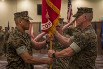 U.S. Marine Corps Col. Scott R. Johnson, passes the regimental colors to Col. Omar J. Randall during a change of command ceremony June 7, 2019, at Camp Kinser, Okinawa, Japan. Johnson, a native of Talkeetna, Alaska, relinquished command of Combat Logistics Regiment 37, 3rd Marine Logistics Group, to Randall, a native of Bronx, New York, during the ceremony. (U.S. Marine Corps photo by Lance Cpl. Terry Wong)