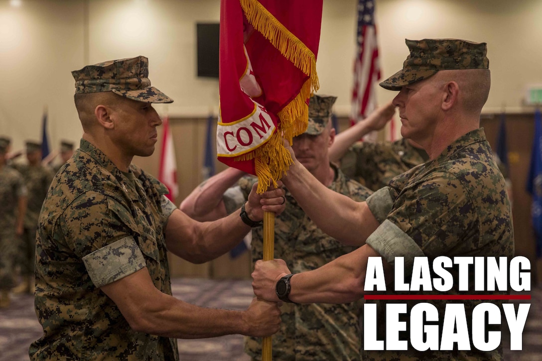 U.S. Marine Corps Col. Scott R. Johnson, passes the regimental colors to Col. Omar J. Randall during a change of command ceremony June 7, 2019, at Camp Kinser, Okinawa, Japan. Johnson, a native of Talkeetna, Alaska, relinquished command of Combat Logistics Regiment 37, 3rd Marine Logistics Group, to Randall, a native of Bronx, New York, during the ceremony. (U.S. Marine Corps photo by Lance Cpl. Terry Wong)