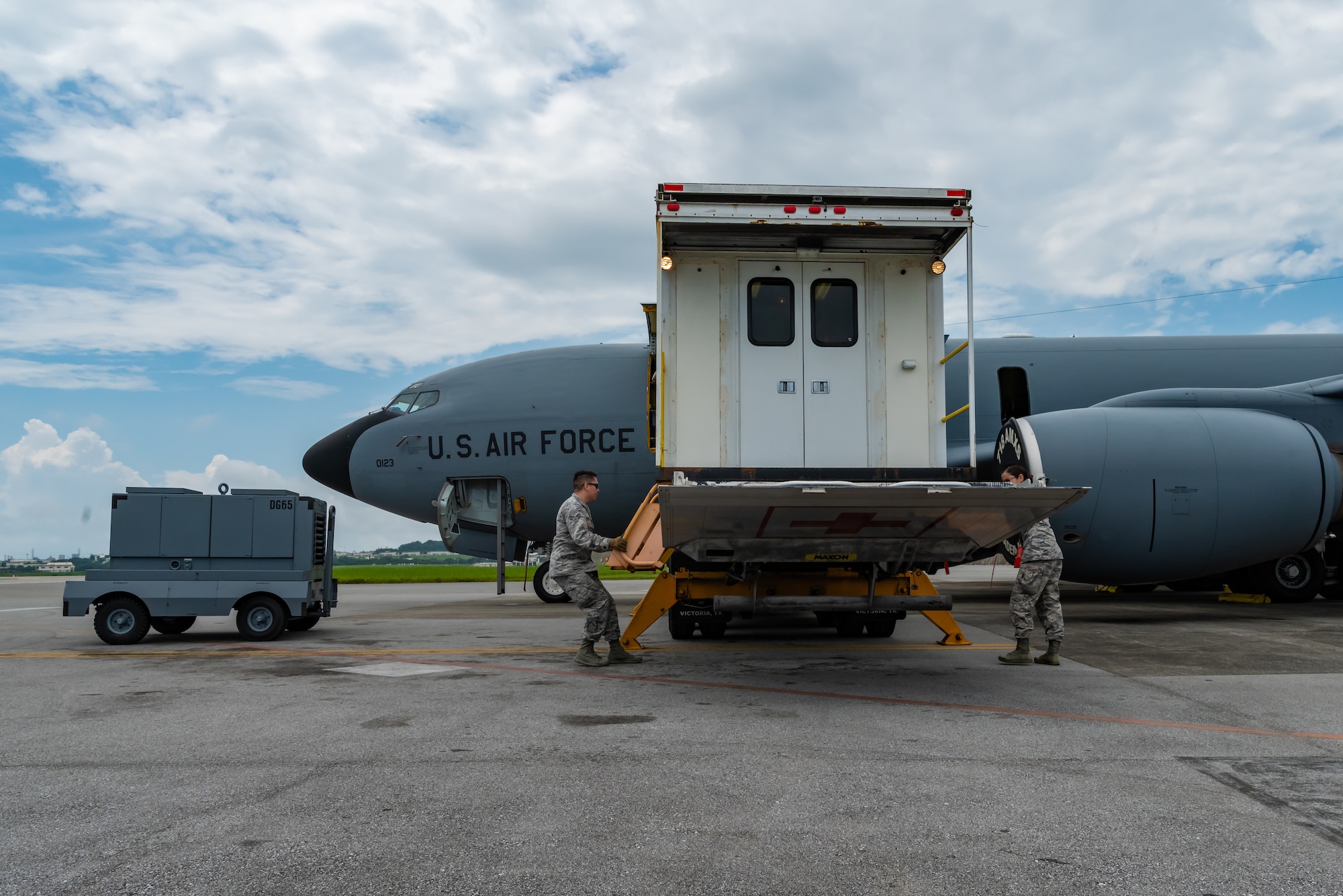 U.S. Air Force Airman 1st Class Eliseo Rios and Airman 1st Class Denisse Monsalve, aerospace medical technicians assigned to the 18th Aerospace Medicine Squadron, lower the high deck patient loading platform during a Neonatal Intensive Care Unit transportation course June 5, 2019, on Kadena Air Base, Japan. The NICU transportation course goes over the roles and responsibilities necessary when transporting an infant patient, what to expect, and what is essential to carry out the mission successfully. (U.S. Air Force photo by Airman 1st Class Cynthia Belío)