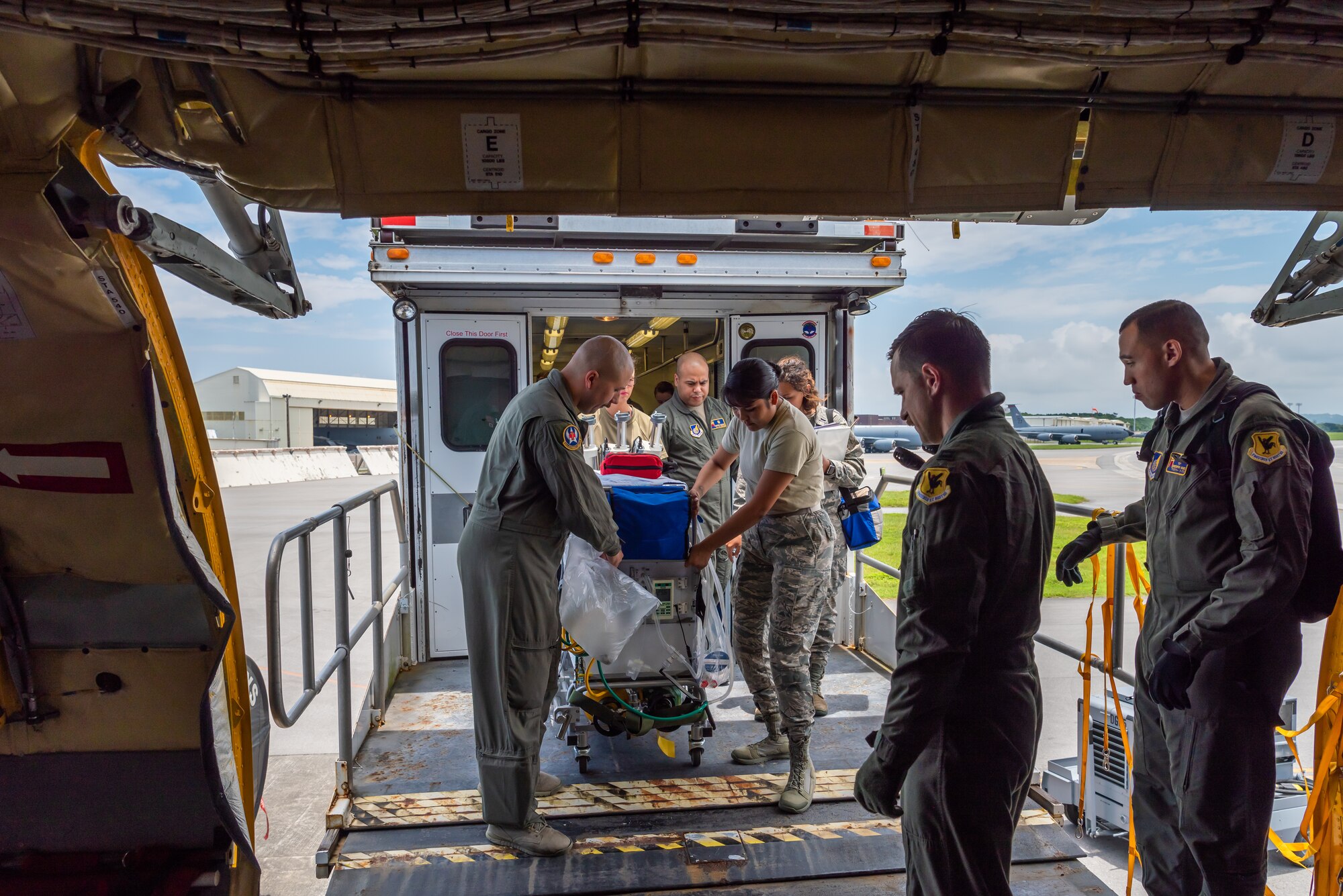 U.S. Air Force Airmen assigned to the 18th Aeromedical Evacuation Squadron and the 18th Aerospace Medicine Squadron load the neonatal transport system onto the KC-135 Stratotanker during a Neonatal Intensive Care Unit transportation course June 5, 2019, on Kadena Air Base, Japan. The NICU transportation course goes over the roles and responsibilities necessary when transporting an infant patient, what to expect, and what is essential to carry out the mission successfully. (U.S. Air Force photo by Airman 1st Class Cynthia Belío)