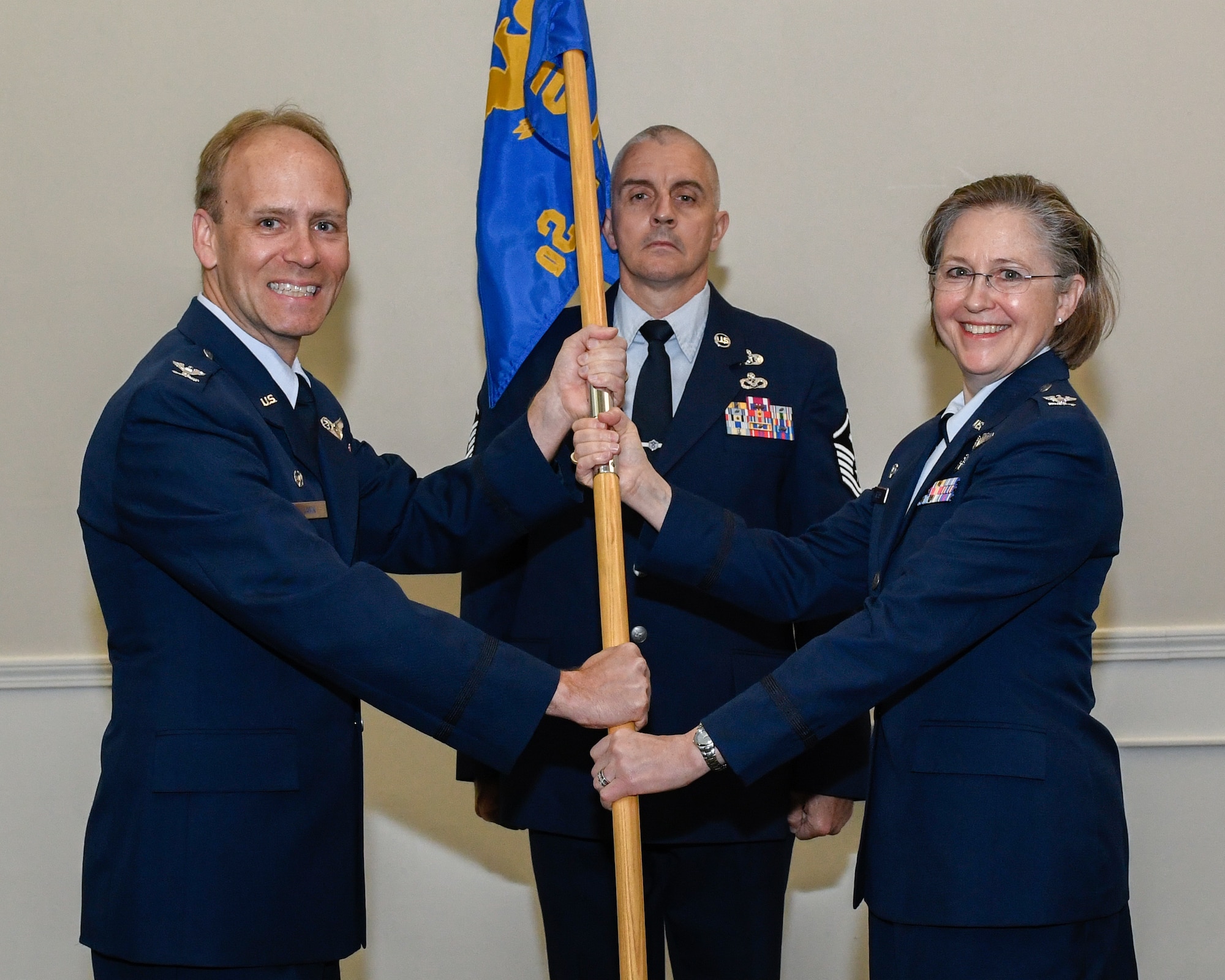 Col. Colleen E. Kelley, the new 910th Medical Squadron (MDS) Commander, receives the 910th MDS’s guidon from Col. Joe Janik, commander of the 910th Airlift Wing (AW), during an assumption of command ceremony June 8, 2019, here.