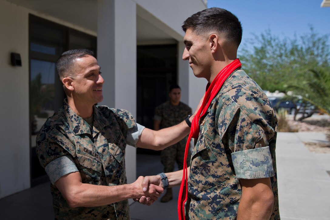 U.S. Marines assigned to Marine Corps Air Station (MCAS) Yuma Headquarters & Headquarters Squadron (H&HS) receive their blood stripes during a Blood Stripe Ceremony at MCAS Yuma Ariz., May 1, 2019. The blood stripe honors the blood that was shed by Marine officers and noncommissioned officers (NCO) during the Battle of Chapultepec in 1847. The blood stripes are worn on the trousers of NCOs Staff NCOs, and officers in remembrance of those who courageously fought in the battle. (U.S. Marine Corps photo by Lance Cpl. Joel Soriano)