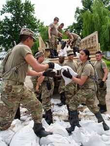 Illinois National Guard Soldiers load sandbags onto truck
