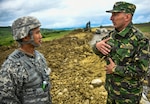 Second Lt. Vincent Owyong, of the 240th Engineer Company based in Las Vegas, Nevada, speaks with a soldier from the Romanian Land Forces (who chooses to be unnamed) during a construction project in Cincu, Romania, May 31st, 2019. The project is part of exercise Resolute Castle 2019, a multi-national joint exercise with real-world outputs of completed construction projects that build and enhance training capabilities around Eastern Europe.