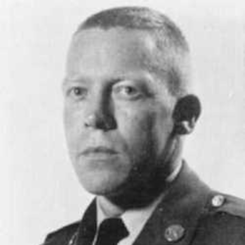 A soldier in dress uniform looks into the camera for an official photo.