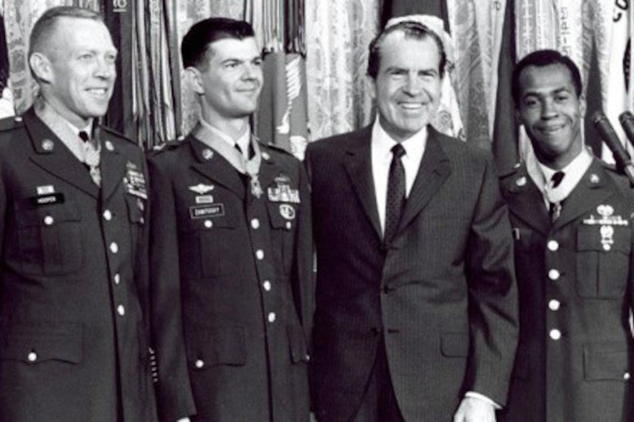 Three soldiers wearing Medals of Honor pose for a photo with President Richard Nixon.