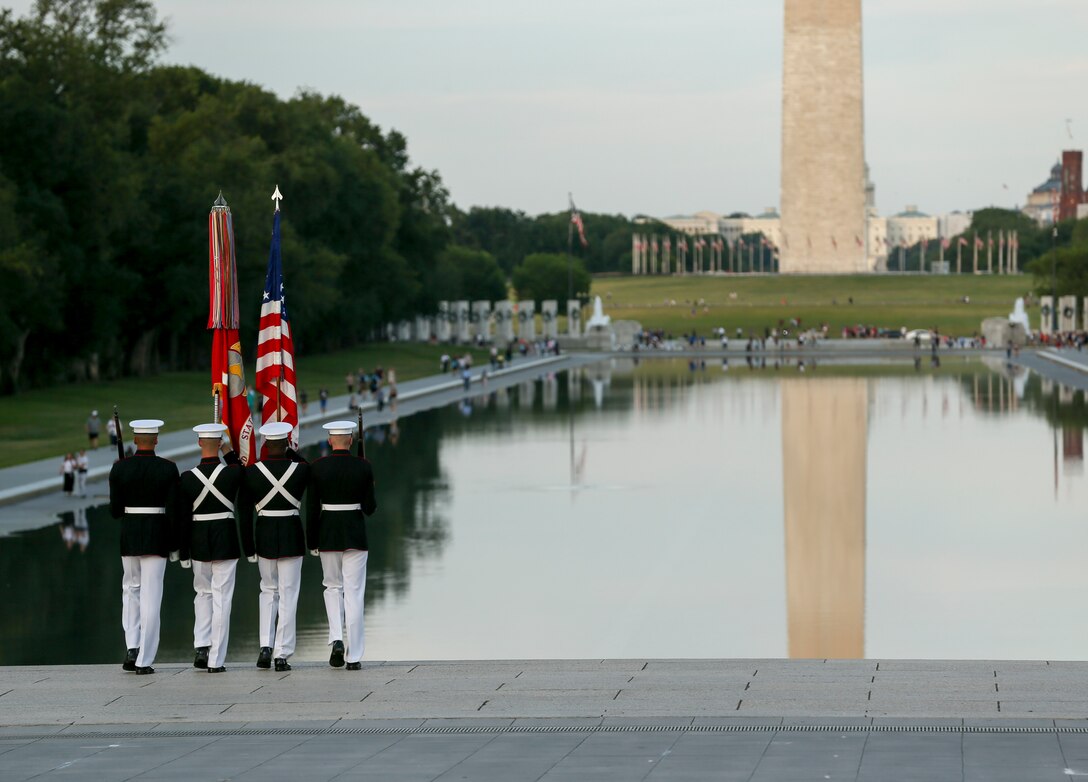 The U.S. Marine Corps Color Guard marches off the parade deck during a Tuesday Sunset Parade at the Lincoln Memorial, Washington, D.C., June 11, 2019. The guest of honor for the evening was William P. Barr, attorney general, and the hosting official was Mr. Robert Hogue, counsel for the commandant of the Marine Corps. (U.S. Marine Corps photo by Pfc. Allen Sanders)