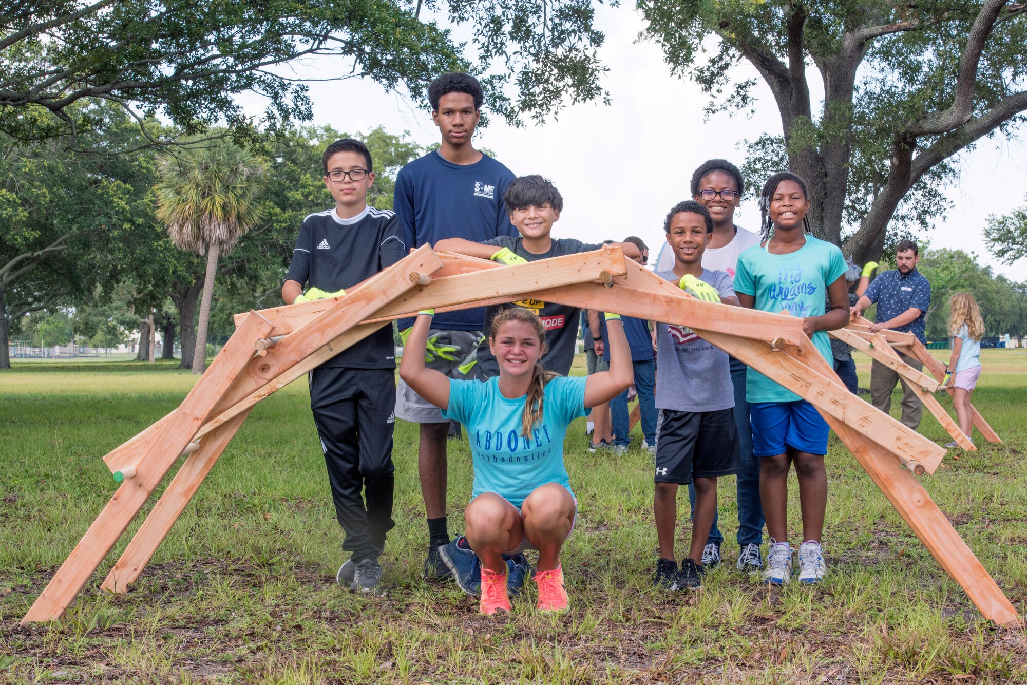 The 6th Force Support Squadron Child Development Center students build a small-scale Leonardo da Vinci self-supporting bridge during a science, technology, engineering and mathematics camp at MacDill Air Force Base, Fla., June 11, 2019.