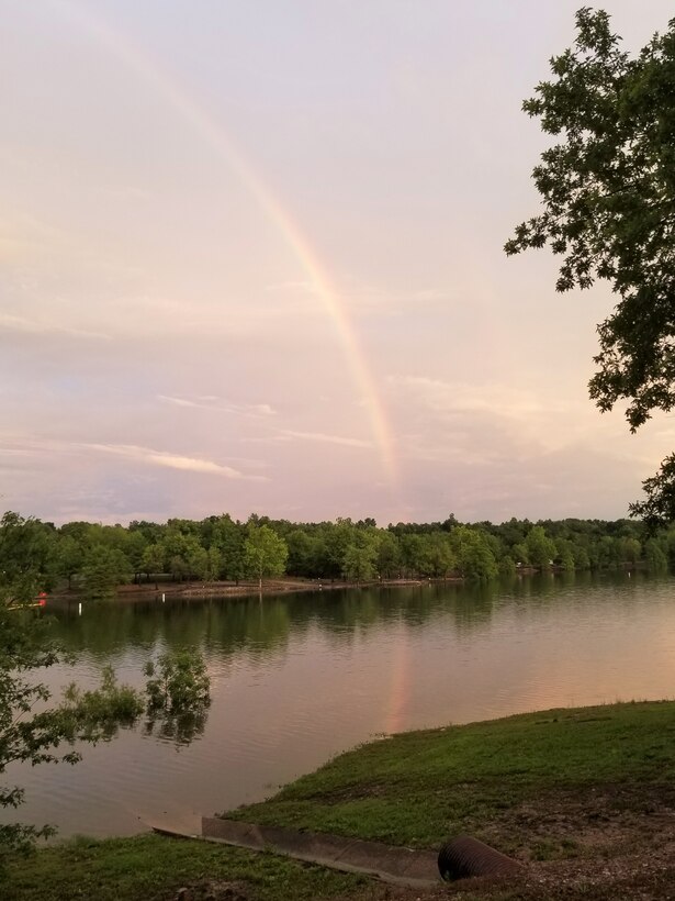 A rainbow reflects over Rough River Lake