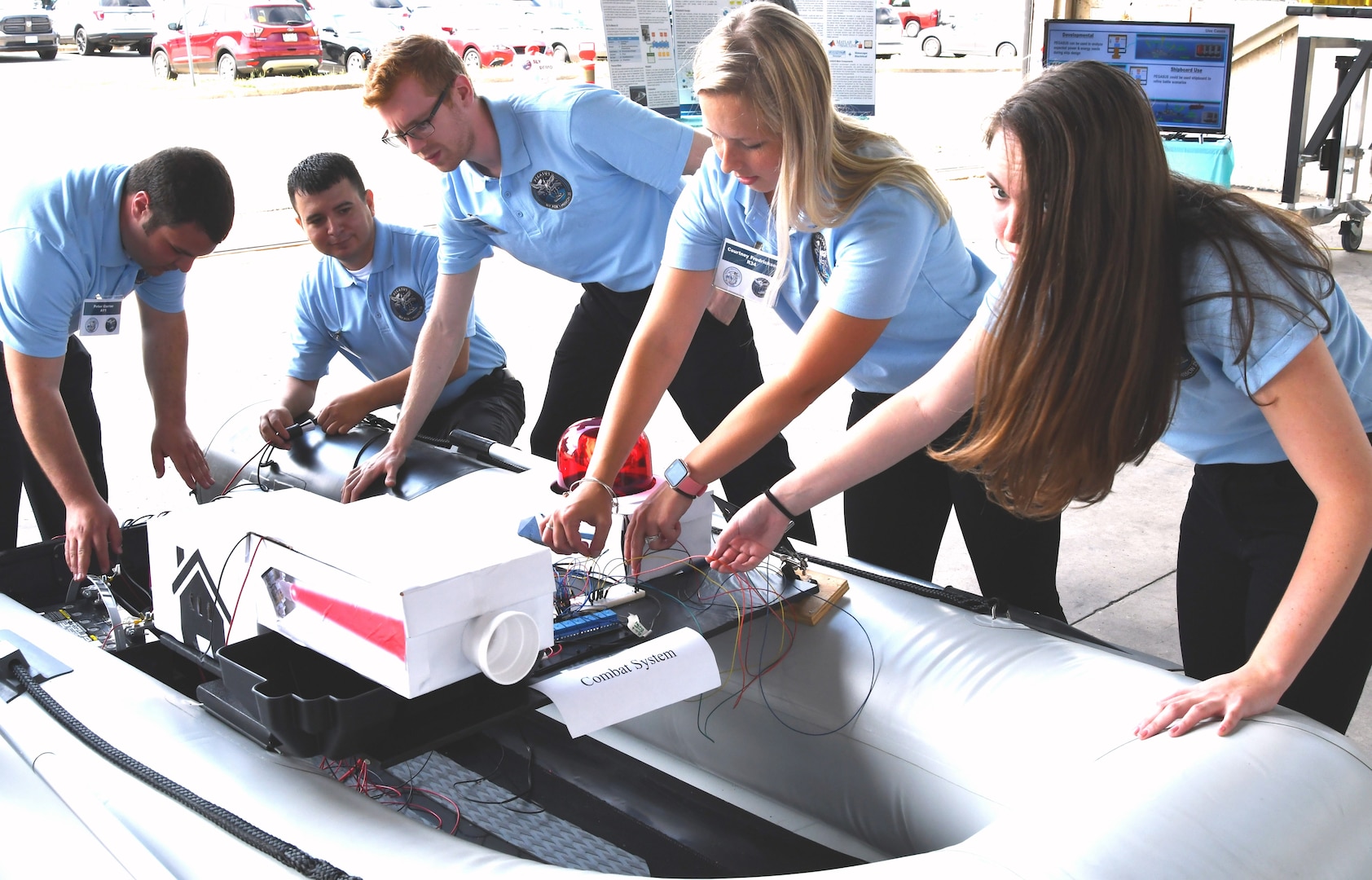 IMAGE: DAHLGREN (June 6, 2019) - The Naval Surface Warfare Center Dahlgren Division (NSWCDD) Sly Fox Mission 25 team in action while demonstrating a hardware representation of PEGASUS – Power and Energy Generation Analysis SimUlation System – capabilities. The team proved the potential of PEGASUS to integrate electric weapons and electric propulsion systems aboard Navy ships in several demonstrations held at NSWCDD. Left to right are Peter Corrao, Daniel Apolinar, Joshua Hellerick, Courtney Fredrickson, and Alexa Thomas.