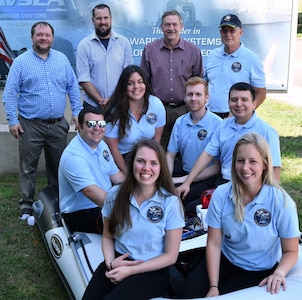 IMAGE: DAHLGREN (June 6, 2019) - The Naval Surface Warfare Center Dahlgren Division (NSWCDD) Sly Fox Mission 25 team and mentors are pictured with a Rigid Hull Inflatable Boat integrated with a hardware representation of PEGASUS – Power and Energy Generation Analysis SimUlation System. The team proved the potential of PEGASUS to integrate electric weapons and electric propulsion systems aboard Navy ships in several demonstrations held at NSWCDD. Left to right in the back row are Sly Fox mentors Thomas Mckelvey, Aaron Albert, Chester Petry, and Tony Scaramozzi. Sly Fox team members in the middle row: Peter Corrao, Marie Zacarias Morro, Joshua Hellerick, and Daniel Apolinar. Sly Fox team members in the front row: Alexa Thomas and Courtney Fredrickson.