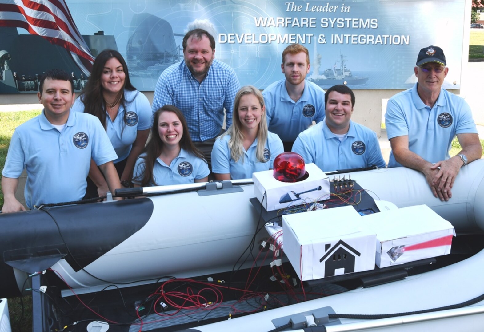 IMAGE: DAHLGREN (June 6, 2019) - The Naval Surface Warfare Center Dahlgren Division (NSWCDD) Sly Fox Mission 25 team and mentors are pictured with a Rigid Hull Inflatable Boat integrated with a hardware representation of PEGASUS – Power and Energy Generation Analysis SimUlation System. The team proved the potential of PEGASUS to integrate electric weapons and electric propulsion systems aboard Navy ships in several demonstrations held at NSWCDD. Left to right in the front row are Daniel Apolinar, Alexa Thomas, Courtney Fredrickson, Peter Corrao and Tony Scaramozzi (mentor). Back row: Marie Zacarias Morro, Thomas Mckelvey (mentor), and Joshua Hellerick.
