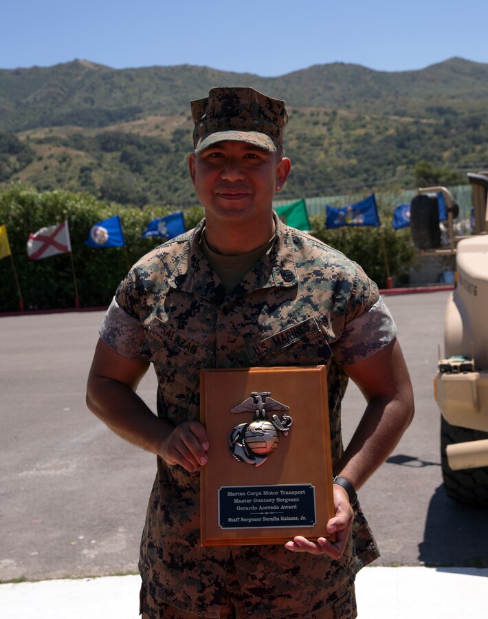 Staff Sgt. Serafin Salazar, Jr., poses with the plaque after receiving the Master Gunnery Sergeant Gerardo Acevedo Award on May 29, 2019, during a ceremony at the School of Infantry West aboard Camp Pendleton, California. The award, formerly known as the “Motor Transport Operation Chief of the Year,” was renamed this year in honor of Master Gunnery Sgt.  Gerardo Acevedo, a motor transport operation chief who passed away Feb. 3, 2018. (U.S. Marine Corps photo by Sgt. Asia J. Sorenson)