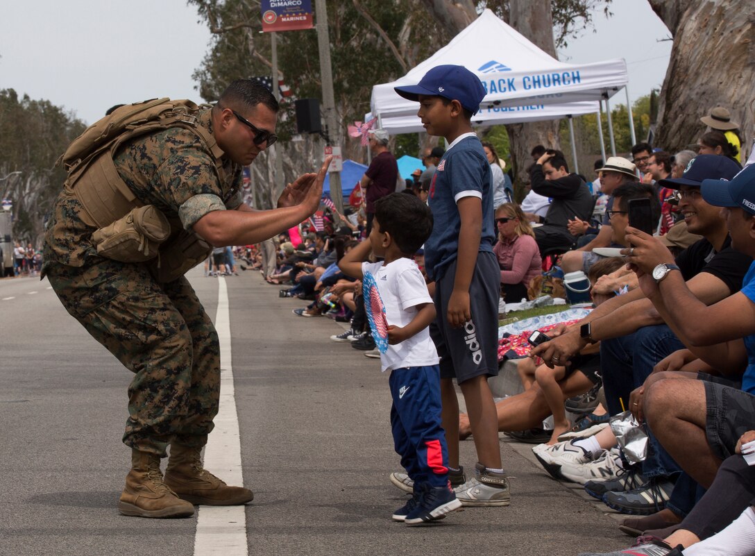 A U.S. Marine high-fives a Torrance resident during the Torrance Armed Forces Day Parade in Torrance, Calif., May 18.