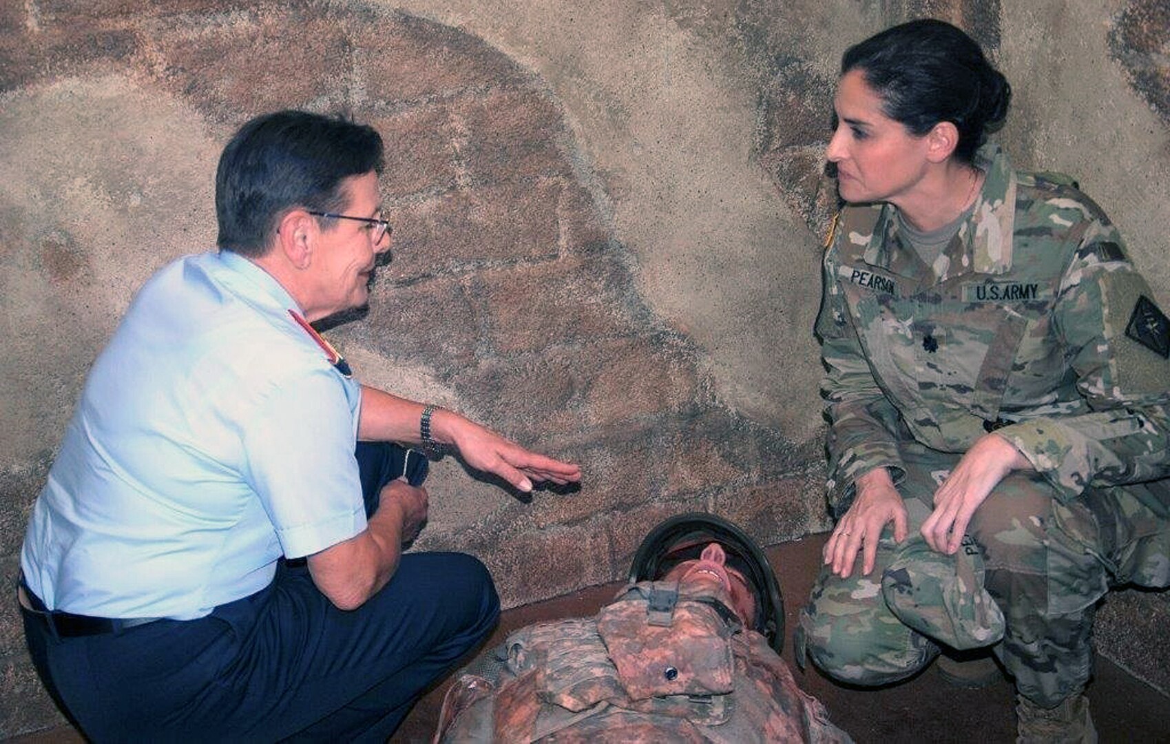 During a visit to the Medical Education and Training Campus at Joint Base San Antonio-Fort Sam Houston June 5, Maj. Gen. Gesine Kruger (left), commander for the German Bundeswehr Medical Academy, receive a brief and tour of combat medic simulated trauma scenario training from Lt. Col. Nadia Pearson, department chair, Combat Medic Training.