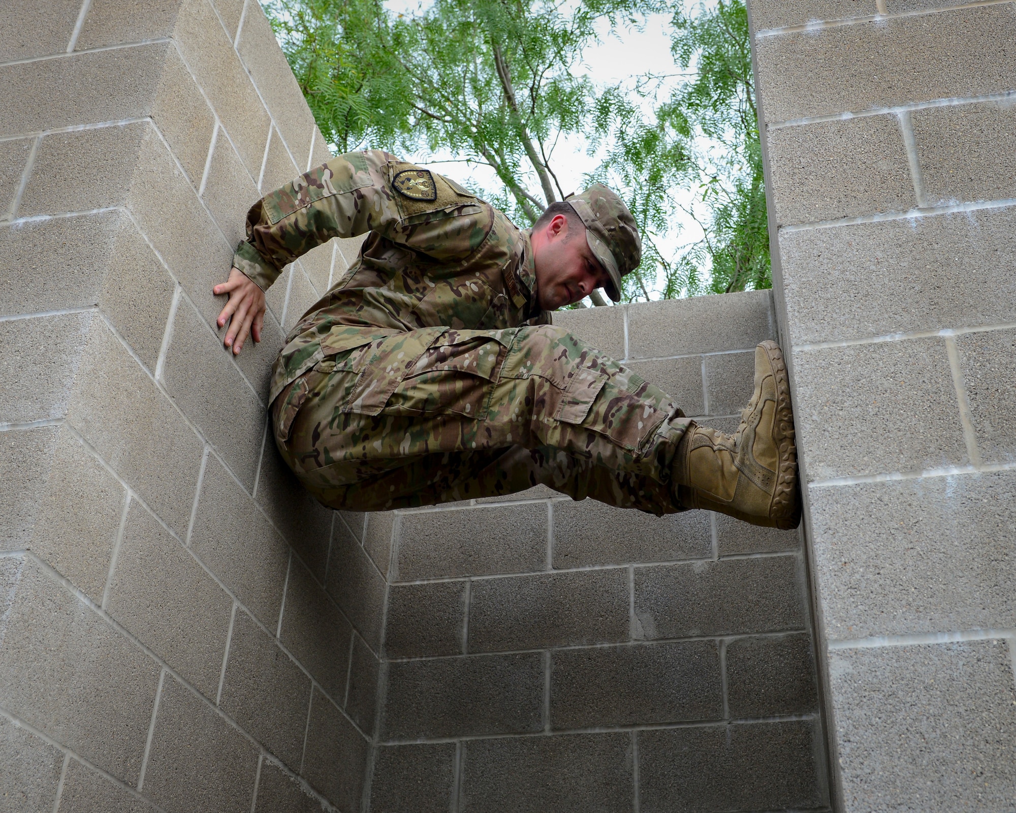 An Air Force recruiter with the 330th Recruiting Squadron practices climbing a wall following instruction from Survival, Evasion, Resistance and Escape (SERE) cadre members from 66th Training Squadron, Det. 3, at Joint Base San Antonio-Lackland June 3, 2019. Survival, Evasion, Resistance and Escape (SERE) cadre from are responsible for both the four-day Evasion and Conduct After Capture Course and the 15-day SERE Specialist Training Orientation Course at Joint Base San Antonio-Lackland. ECAC was the first stop for recruiters from the 330th RCS who travelled from across the United States to attend this biannual squadron training intended to immerse recruiters into SERE training  in order for them to be better able  to recruit Air Force SERE candidates.