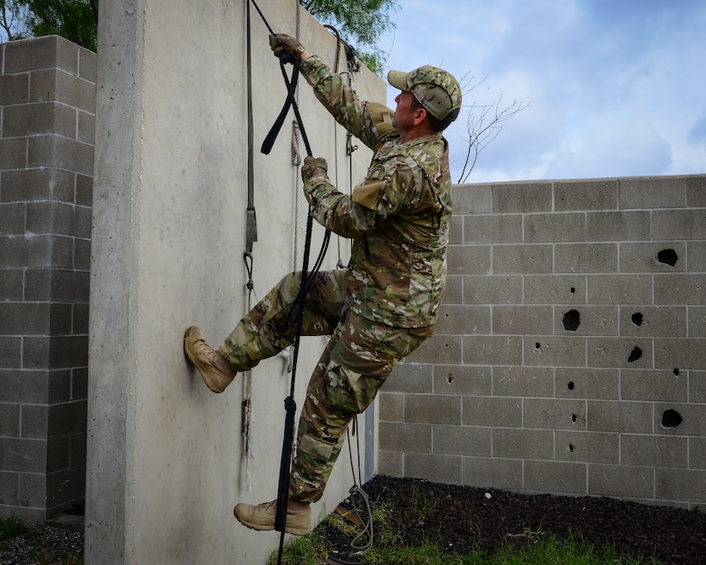 Air Force Master Sgt. Travis Mooney, 66th Training Squadron, Det. 3 cadre, demonstrates how to use survival items or debris to safely scale a wall in an isolation or evasion-type environment, June 3, 2019. Survival, Evasion, Resistance and Escape (SERE) cadre from are responsible for both the four-day Evasion and Conduct After Capture Course and the 15-day SERE Specialist Training Orientation Course at Joint Base San Antonio-Lackland. ECAC was the first stop for recruiters from the 330th RCS who travelled from across the United States to attend this biannual squadron training intended to immerse recruiters into SERE training  in order for them to be better able  to recruit Air Force SERE candidates.
