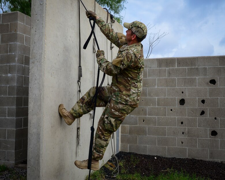 Air Force Master Sgt. Travis Mooney, 66th Training Squadron, Det. 3 cadre, demonstrates how to use survival items or debris to safely scale a wall in an isolation or evasion-type environment, June 3, 2019. Survival, Evasion, Resistance and Escape (SERE) cadre from are responsible for both the four-day Evasion and Conduct After Capture Course and the 15-day SERE Specialist Training Orientation Course at Joint Base San Antonio-Lackland. ECAC was the first stop for recruiters from the 330th RCS who travelled from across the United States to attend this biannual squadron training intended to immerse recruiters into SERE training  in order for them to be better able  to recruit Air Force SERE candidates.