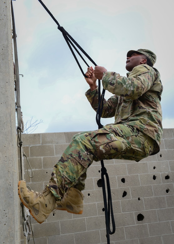 An Air Force recruiter with the 330th Recruiting Squadron practices scaling a wall following instruction from Survival, Evasion, Resistance and Escape (SERE) cadre members from 66th Training Squadron, Det. 3,  at Joint Base San Antonio-Lackland June 3, 2019. Survival, Evasion, Resistance and Escape (SERE) cadre from are responsible for both the four-day Evasion and Conduct After Capture Course and the 15-day SERE Specialist Training Orientation Course at Joint Base San Antonio-Lackland. ECAC was the first stop for recruiters from the 330th RCS who travelled from across the United States to attend this biannual squadron training intended to immerse recruiters into SERE training  in order for them to be better able  to recruit Air Force SERE candidates.