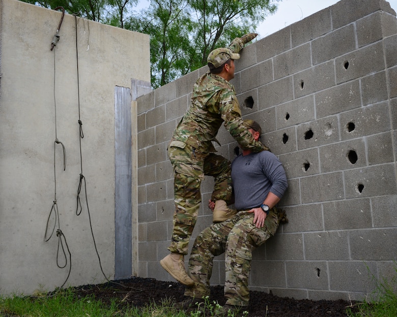 Air Force Survival, Evasion, Resistance and Escape (SERE) cadre members from 66th Training Squadron, Det. 3, at Joint Base San Antonio-Lackland demonstrate how two individuals can safely and effectively scale a wall in an evasion-type environment, June 3, 2019. Survival, Evasion, Resistance and Escape (SERE) cadre from are responsible for both the four-day Evasion and Conduct After Capture Course and the 15-day SERE Specialist Training Orientation Course at Joint Base San Antonio-Lackland. ECAC was the first stop for recruiters from the 330th RCS who travelled from across the United States to attend this biannual squadron training intended to immerse recruiters into SERE training  in order for them to be better able  to recruit Air Force SERE candidates.