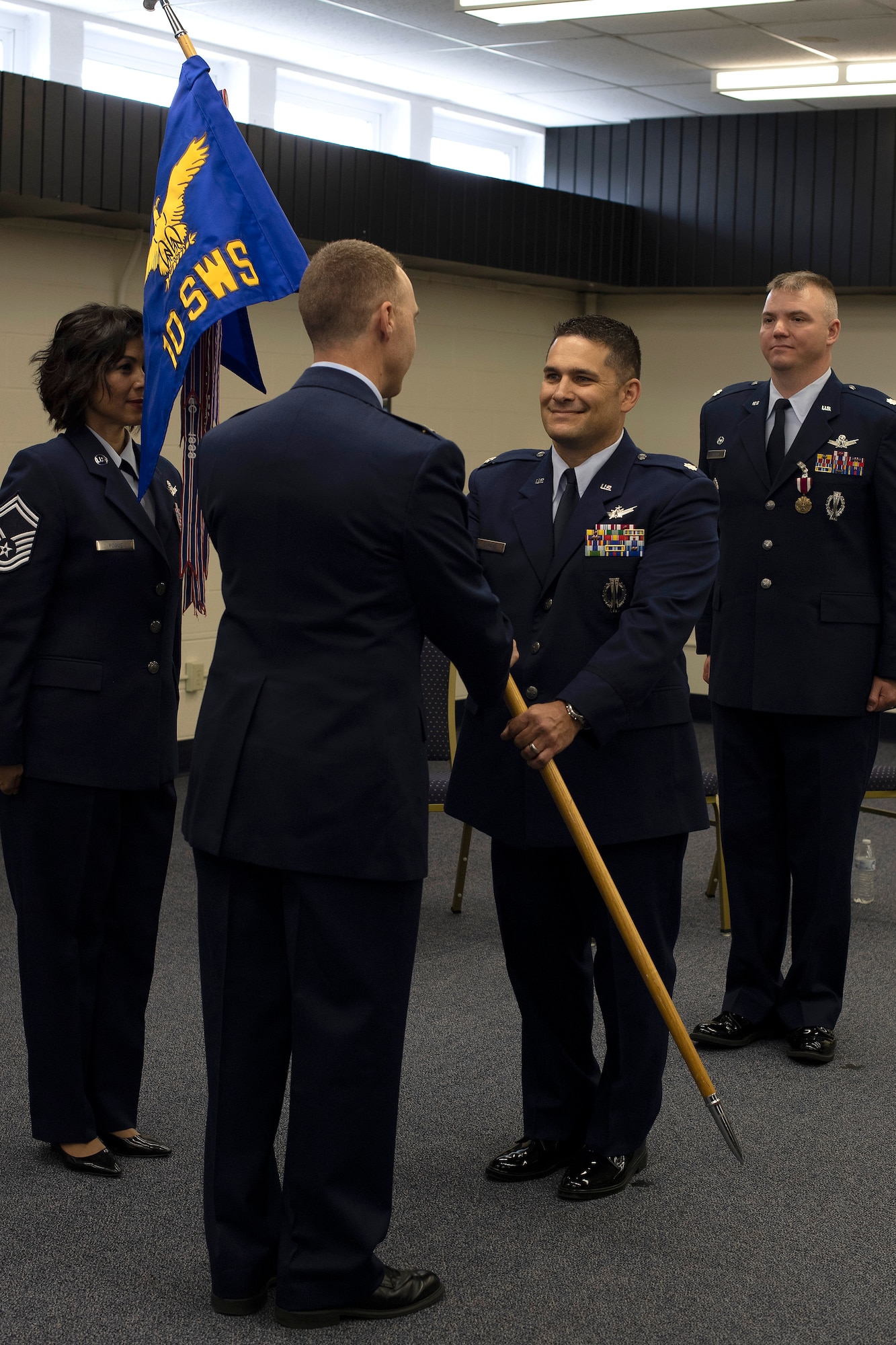 Lt. Col. Ryan Durand, incoming commander for the 10th Space Warning Squadron, accepts command during a ceremony June 11, 2019, on Cavalier Air Force Station, North Dakota. Durand assumed command from outgoing commander, Lt. Col. Stephen Hobbs. (U.S. Air Force photo by Senior Airman Elora J. Martinez)