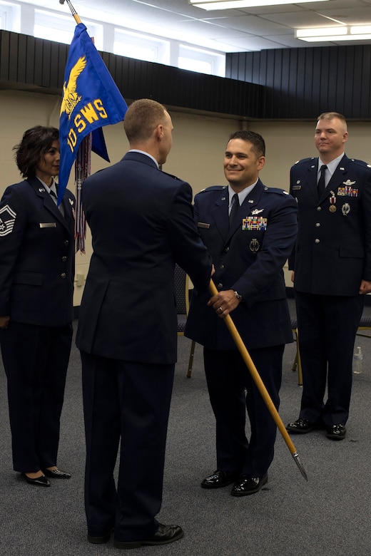 Lt. Col. Ryan Durand, incoming commander for the 10th Space Warning Squadron, accepts command during a ceremony June 11, 2019, on Cavalier Air Force Station, North Dakota. Durand assumed command from outgoing commander, Lt. Col. Stephen Hobbs. (U.S. Air Force photo by Senior Airman Elora J. Martinez)