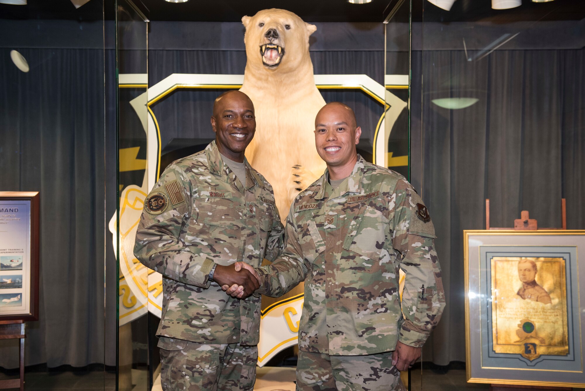 U.S. Air Force Tech. Sgt. Dennis Mendoza, 673d Air Base Wing noncommissioned officer in charge of executive administration, receives a coin from Chief Master Sergeant of the Air Force Kaleth O. Wright, at Alaskan Command, Joint Base Elmendorf-Richardson, Alaska, June 10, 2019. Chief Wright visited JBER during Red Flag-Alaska to meet with senior enlisted leader counterparts from throughout the Pacific. Red Flag-Alaska is a Pacific Air Forces-directed exercise that allows U.S. forces to train with coalition partners in a simulated environment.