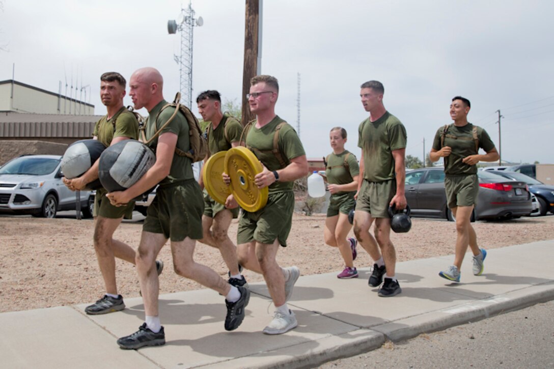 U.S. Marines with Communications Squadron 28, Marine Corps Air Station Cherry Point conduct physical training at Marine Corps Air Station Yuma Ariz., May 2, 2019. U.S. Marines stay in shape by training their bodies and minds during vigorous physical activities to ensure combat readiness at all times. (U.S. Marine Corps photo by Lance Cpl. Joel Soriano)