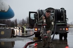 U.S. Air Force Senior Airman Aaron Dobizl, 673d Logistics Readiness Squadron, carries a fuel line while preparing to refuel Air Force Two while Vice President of the United States Mike Pence visits Joint Base Elmendorf-Richardson, Alaska, Nov. 11, 2018. The vice president is beginning a visit to Asia, and took time to visit the installation in observance of Veterans Day to meet and speak with service members and veterans of all branches.