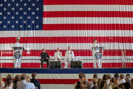 Capt. Dianna Wolfson (right) addresses the audience at the Puget Sound Naval Shipyard & Intermediate Maintenance Facility change of command ceremony June12. Wolfson relieved Capt. Howard Markle (seated, right) at the ceremony. Vice Adm. Thomas Moore, commander of Naval Sea Systems Command (seated, center), presided over the ceremony.
