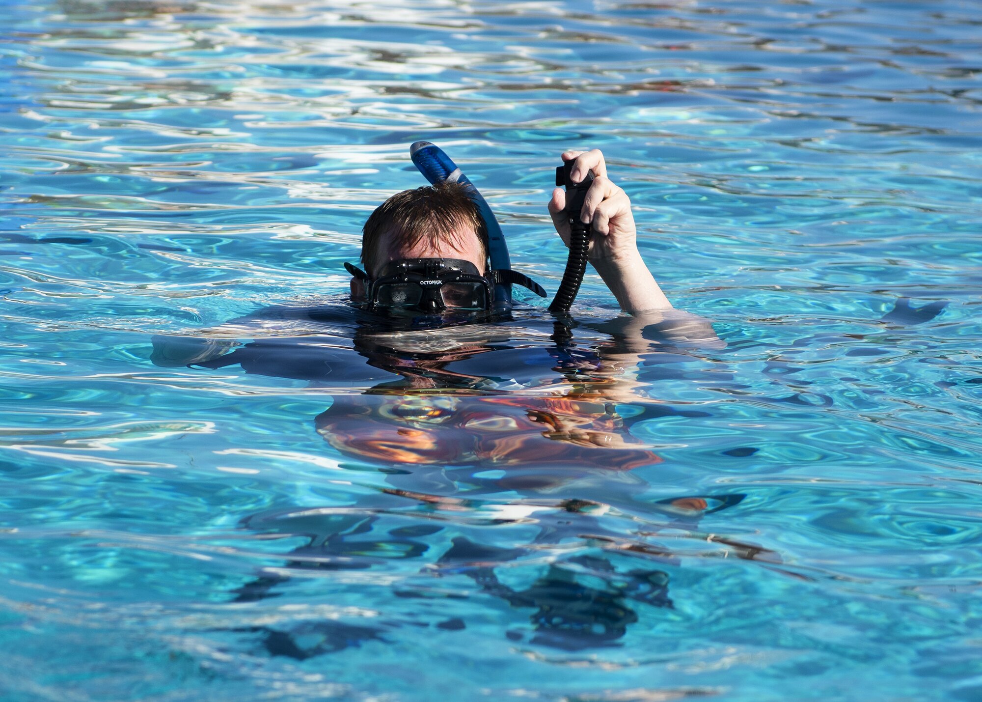 A scuba student empties the air out of his buoyancy compensator during a scuba diving class June 8, 2019, at Luke Air Force Base, Ariz.