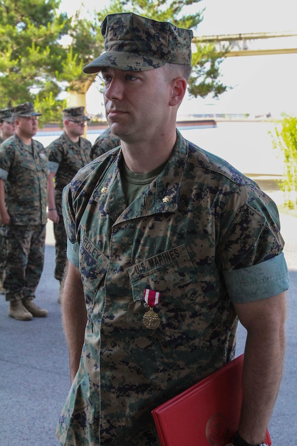 CAMP HUMPHREYS, Republic of Korea – Maj. Adam Foley, U.S. Marine Corps Forces Korea G4 engineer officer, is awarded the Meritorious Service Medal during an awards ceremony here, June 13. Foley was awarded the Meritorious Service Medal for his devotion to duty during his time in service with MARFORK. (Official U.S. Marine Corps photo by Sgt. Nathaniel Hanscom/Released)