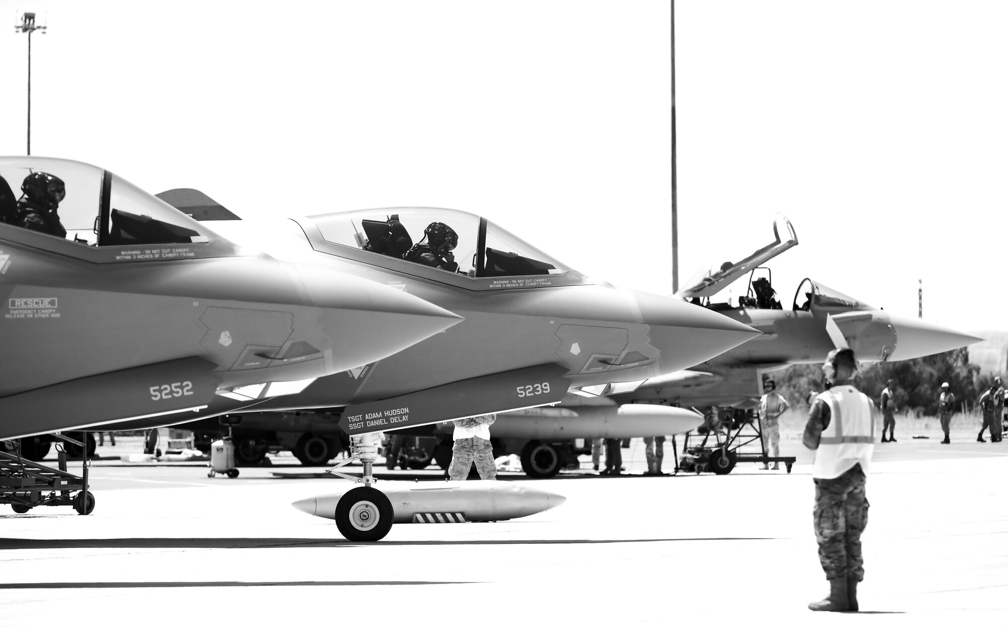 Airman stands ready to direct F-35A aircraft for taxi and takeoff.