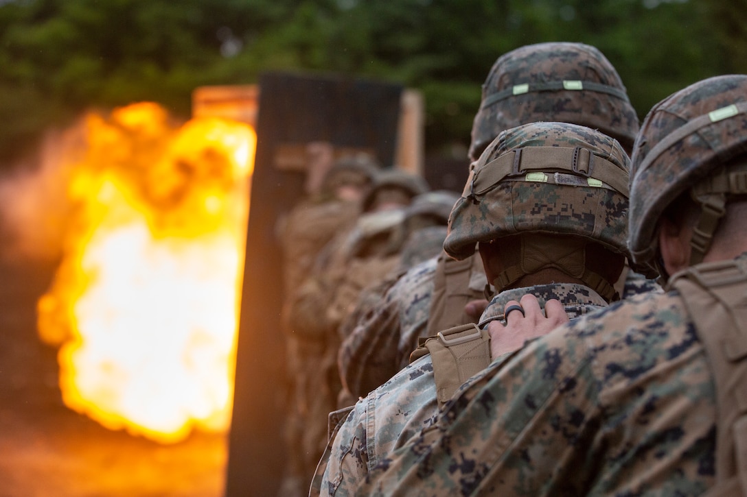 U.S. Marines with 2nd Combat Engineer Battalion, currently attached to 3rd Battalion, 6th Marine Regiment, currently assigned to 4th Marine Regiment, 3rd Marine Division under the Unit Deployment Program, stand behind a wooden shield during an urban-breaching range on Exercise Fuji Viper, at Combined Arms Training Center, Camp Fuji, June 11, 2019. Marines train in urban-breaching to increase proficiency in house-to-house style fighting.