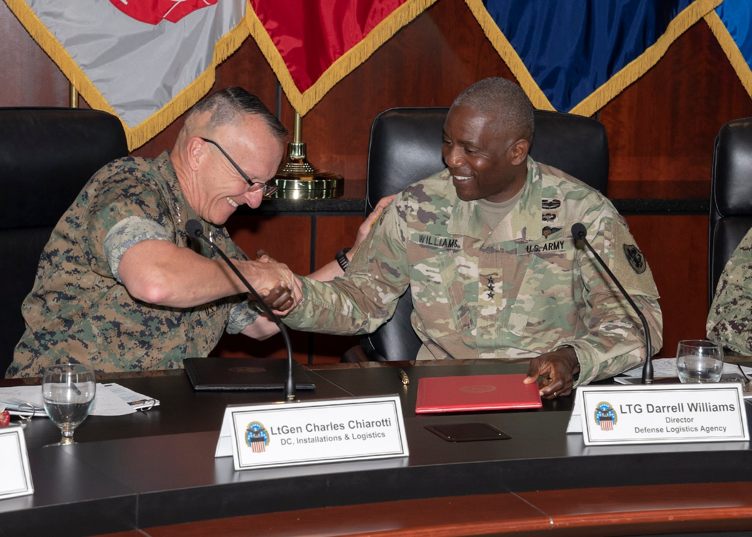 Two men shake hands after the 2019 Marine Corps-DLA Day.