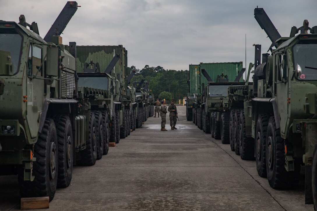 U.S. Marines with 2nd Transportation Support Battalion, Combat Logistics Regiment 2, 2nd Marine Logistics Group, clean the inside of vehicles while staged to be loaded on to the USNS Watkins (T-AKR-315) during exercise Resolute Sun at Joint Base Charleston, South Carolina, June 11, 2019. Marines participated in the exercise to increase major combat operational readiness in amphibious and prepositioning operations while conducting joint training with the U.S. Army during a joint logistics over the shore scenario. (U.S. Marine Corps photo by Lance Cpl. Scott Jenkins)