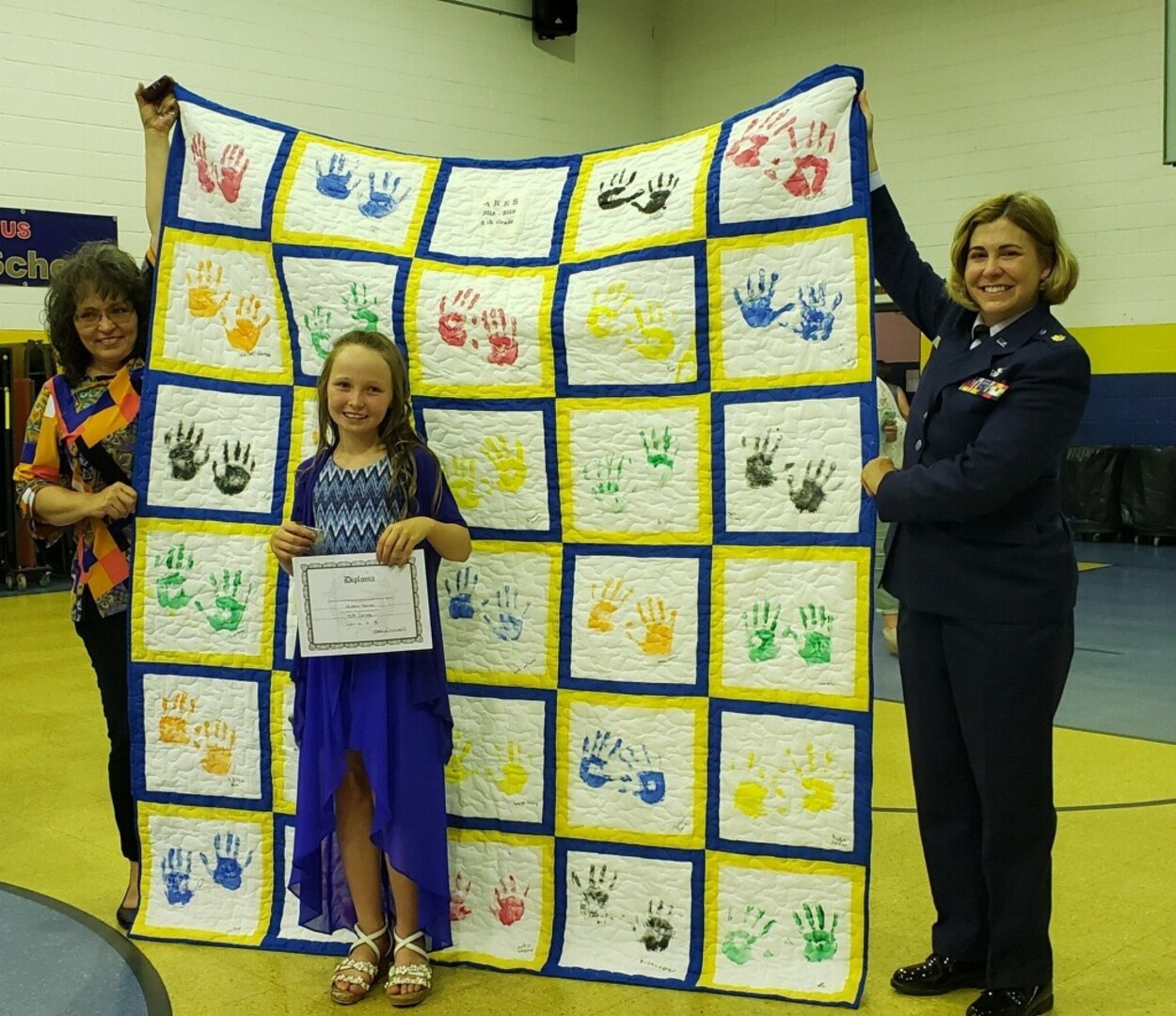 Maj. Stacy Brown is presented a hand-made quilt from students at Ashford Rumble Elementary School in Ashford, West Virginia, at the end of the 2018-2019 school year. Brown is the West Virginia National Guard's Drug Demand Reduction (DDR) program coordinator and has mentored students at the school for the past year. (Courtesy photo)