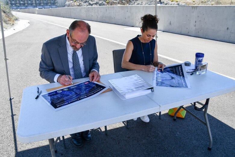 man and woman sign document