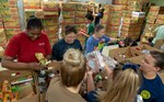 Navy Medicine Education, Training and Logistics Command Sailors sort food during a volunteer community outreach event at the San Antonio Food Bank June 11. The outreach event was part of the Navy’s Sailor 360, a command-level program for junior enlisted, senior enlisted and junior officers, designed to strengthen and develop leadership through outreach events, classroom discussions and physical training.