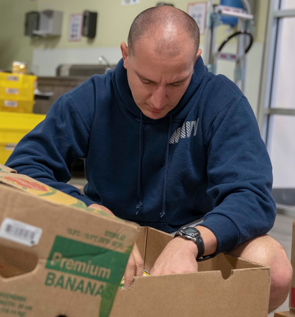 Lt. Marc Hendel, Navy Medicine Education, Training and Logistics Command staff judge advocate, sorts food during a volunteer community outreach event at the San Antonio Food Bank. The outreach event was part of the Navy’s Sailor 360, a command-level program for junior enlisted, senior enlisted and junior officers, designed to strengthen and develop leadership through outreach events, classroom discussions and physical training.