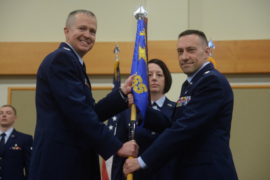 Guidon bearer Master Sgt. Kimberly Severyn, looks on.