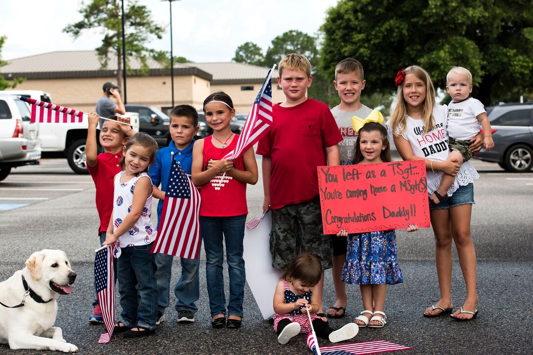 Children of Airmen from the 38th Rescue Squadron (RQS) pose for a photo during a redeployment, June 10, 2019, at Moody Air Force Base, Ga. Personnel from the 38th RQS deployed as part of Combined Joint Task Force-Horn of Africa where they provided robust personnel recovery capabilities to support the security objectives of United States Africa Command and United States European Command. (U.S. Air Force photo by Senior Airman Erick Requadt)