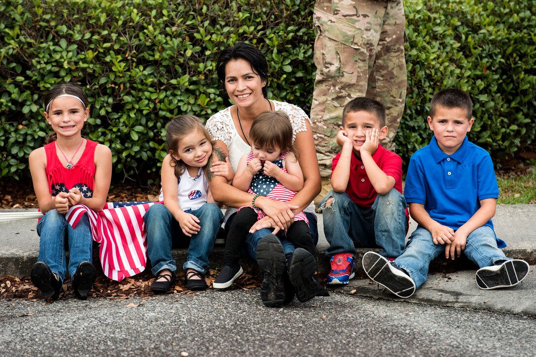 Family members of Staff Sgt. Michael Valeich, 38th Rescue Squadron (RQS) pararescueman, pose for a photo during a redeployment, June 10, 2019, at Moody Air Force Base, Ga.  Personnel from the 38th RQS deployed as part of Combined Joint Task Force-Horn of Africa where they provided robust personnel recovery capabilities to support the security objectives of United States Africa Command and United States European Command. (U.S. Air Force photo by Senior Airman Erick Requadt)