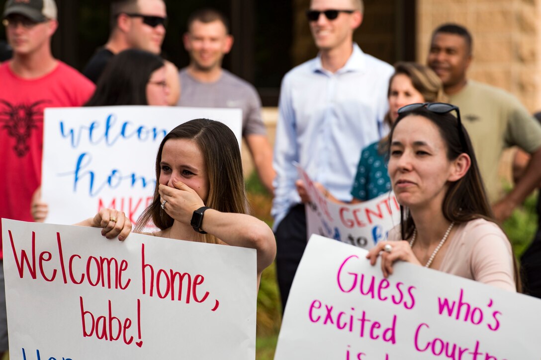 Family and friends of Airmen from the 38th Rescue Squadron (RQS) watch as their loved ones return during a redeployment, June 10, 2019, at Moody Air Force Base, Ga. Personnel from the 38th RQS deployed as part of Combined Joint Task Force-Horn of Africa where they provided robust personnel recovery capabilities to support the security objectives of United States Africa Command and United States European Command. (U.S. Air Force photo by Senior Airman Erick Requadt)