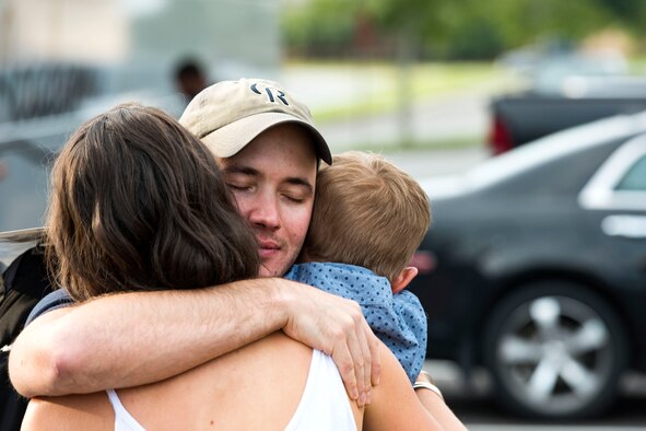 Capt. Haralambos Theologis, 38th Rescue Squadron (RQS) combat rescue officer, hugs his family during a redeployment, June 10, 2019, at Moody Air Force Base, Ga. Personnel from the 38th RQS deployed as part of Combined Joint Task Force-Horn of Africa where they provided robust personnel recovery capabilities to support the security objectives of United States Africa Command and United States European Command. (U.S. Air Force photo by Senior Airman Erick Requadt)